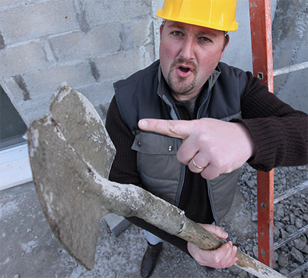 Construction worker explaining a tool